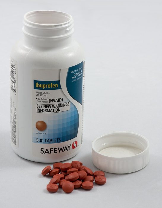 Bottle of ibuprofen tablets with cap removed